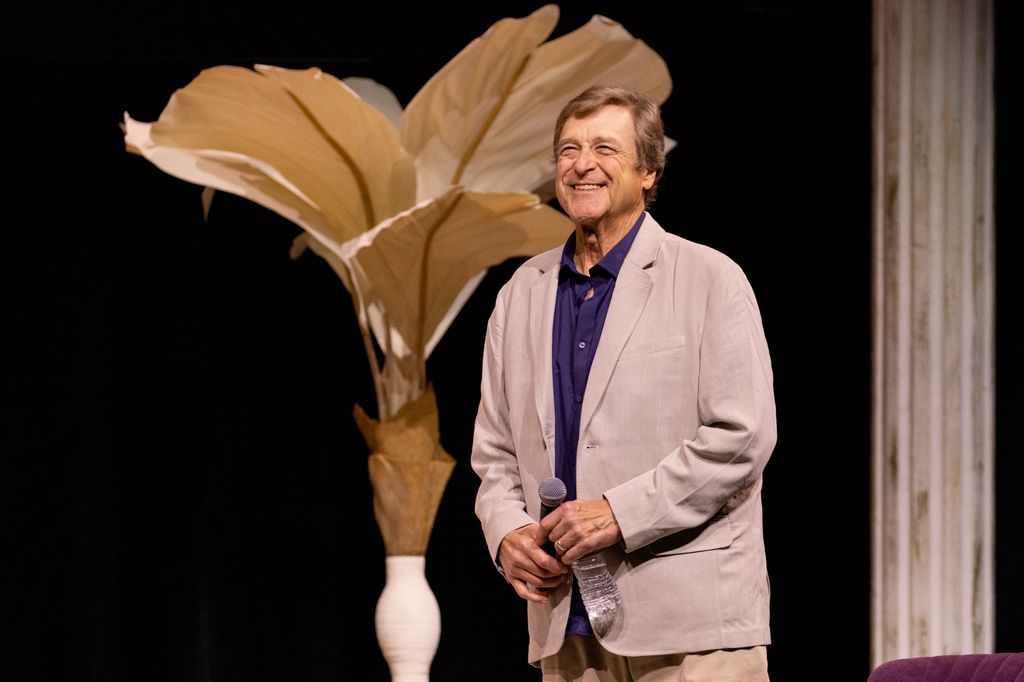 John Goodman on stage in a stone jacket